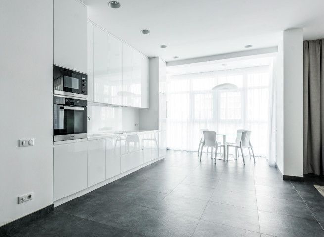 Newly tiled Swansea kitchen floor with black large format porcelain tiles.